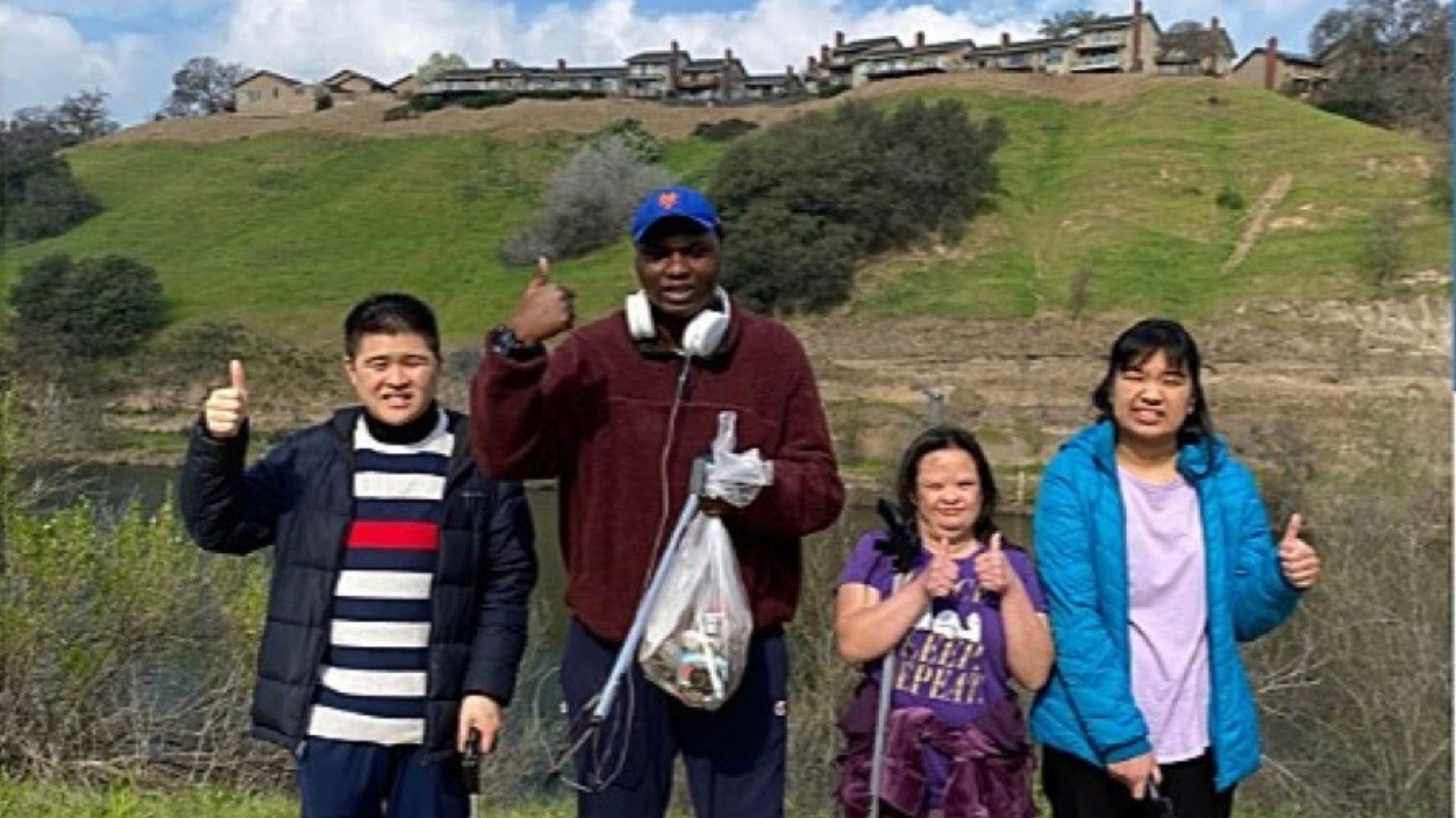David, Kenney, Elizabeth, and Angelica posing together during a volunteer outing at a local fish hatchery in Sacramento