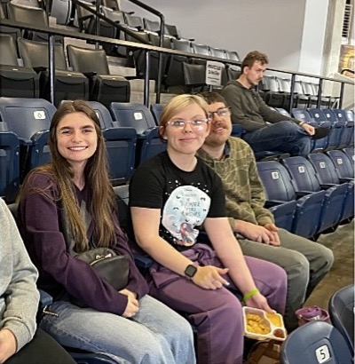 Ashley, Hayley, Joseph, and Pierce enjoying snacks and watching a Stockton Kings basketball game from their arena seats 