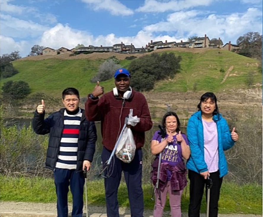 David, Kenney, Elizabeth, and Angelica posing together during a volunteer outing at a local fish hatchery in Sacramento