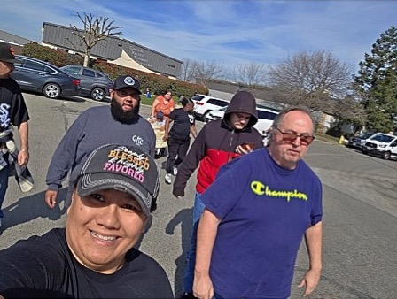 Members of Visalia’s walking club enjoying a group walk outdoors on a sunny day as part of their wellness activities