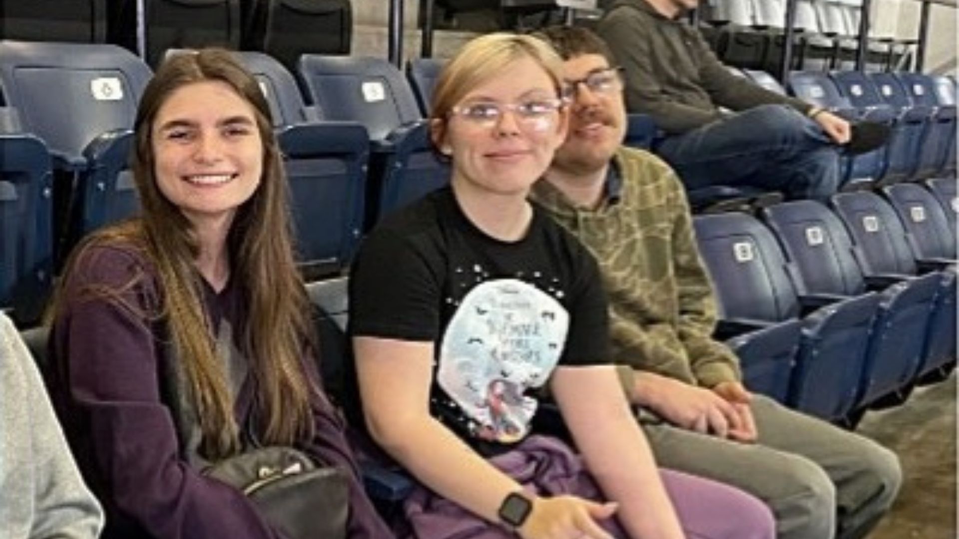 Ashley, Hayley, Joseph, and Pierce enjoying snacks and watching a Stockton Kings basketball game from their arena seats 