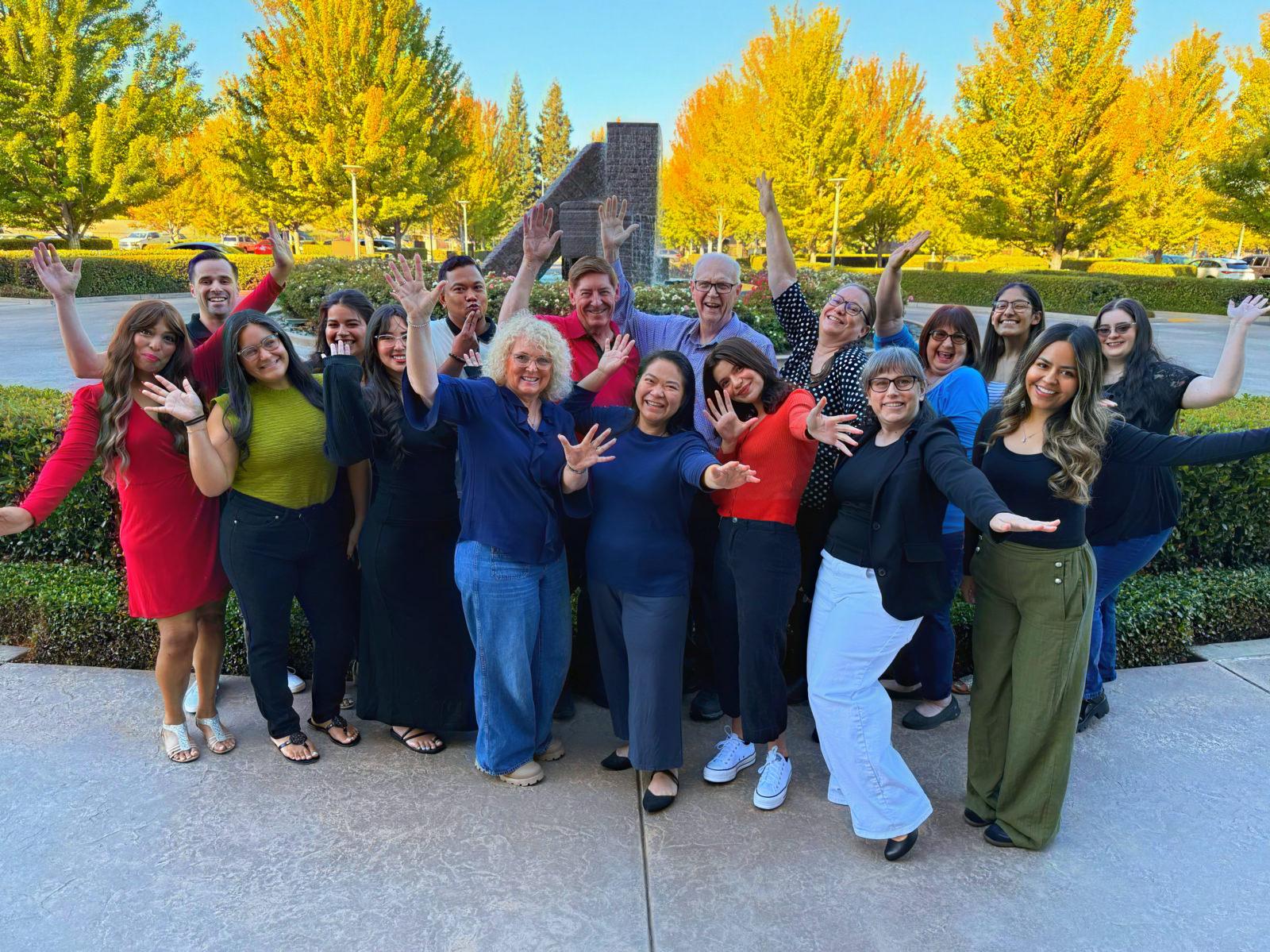 CVTC staff posing with raised hands