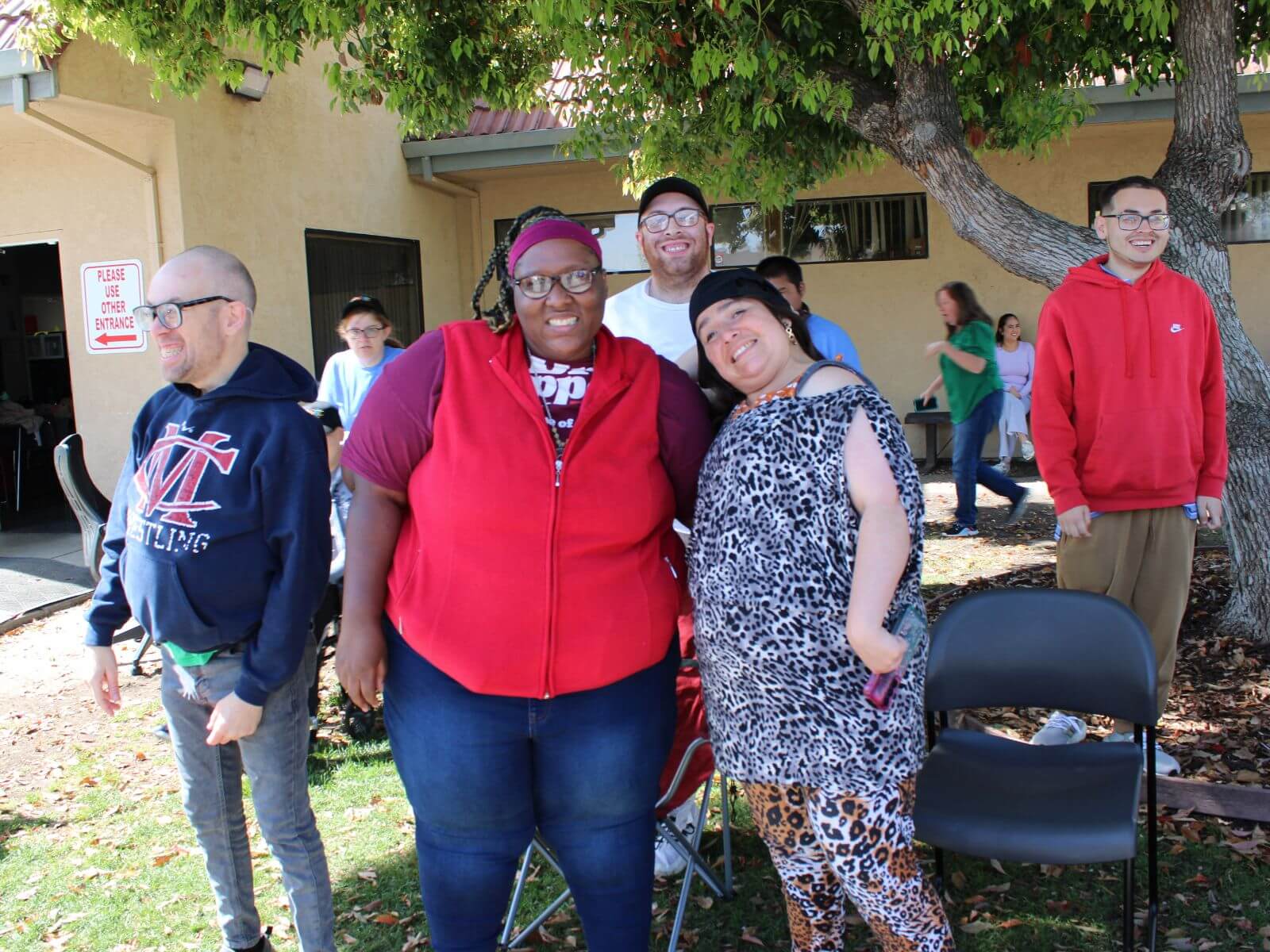 CV Training Center adult day program participants smiling and socializing at outdoor event in Stockton, CA