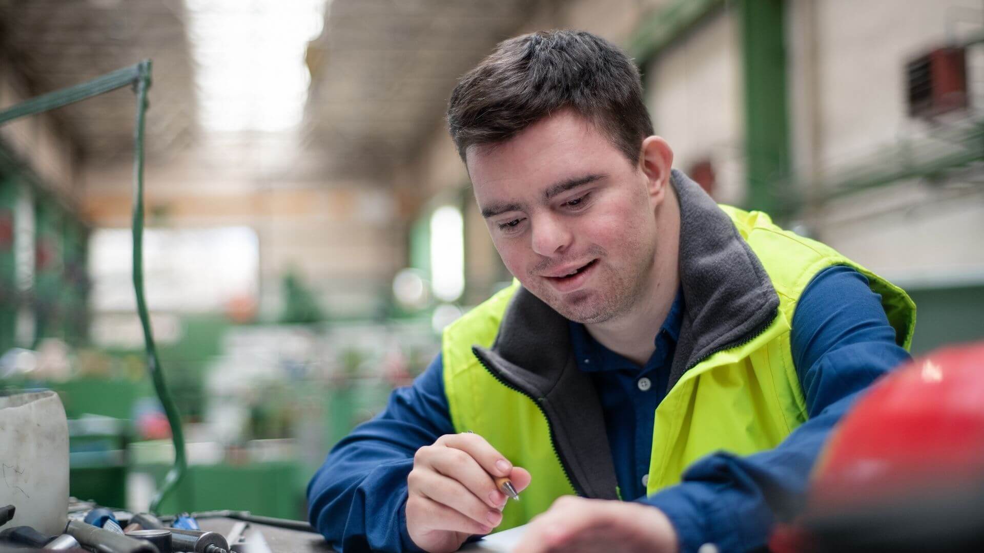 Adult man with developmental disability completing vocational training in workshop setting