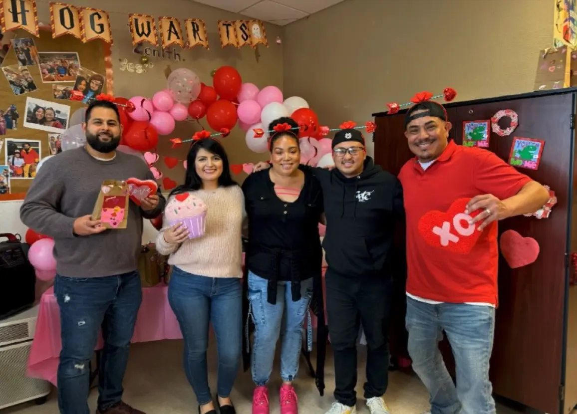 Program Coordinator, Jonsebas- tian G., Program Director, Touchinue L., Program Coor- dinators Brionna H., and Moriah G, Regional Director of Operations, Aaron W standing with Valentines Day props.