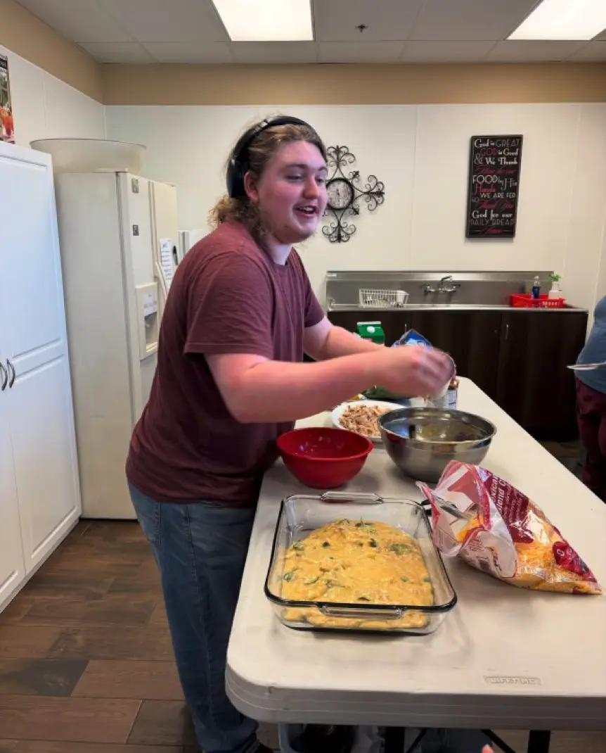Kyle standing in the kitchen preparing meals.