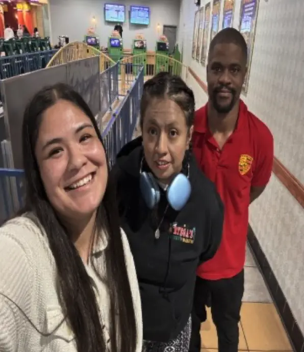 Syrena, Cristian, James standing in a retail store, smiling.