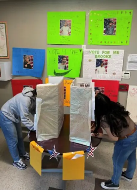 Ashley and Liz at the voting booth, casting their vote.